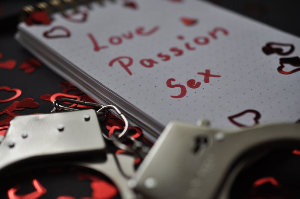 notepad with "Love, Passion, Sex" written on it